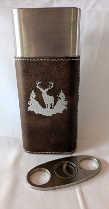 Rawhide cigar holder with silver buck engraving includes cigar cutter.